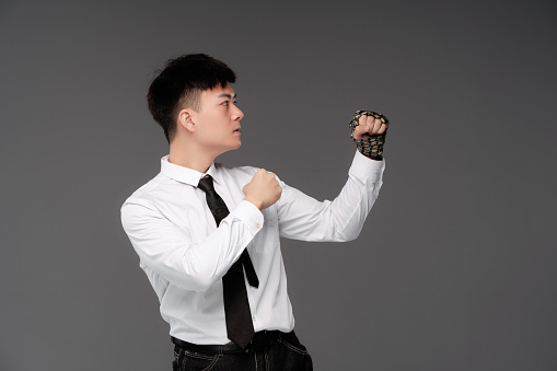 Young Asian white-collar workers, put on a fighting posture