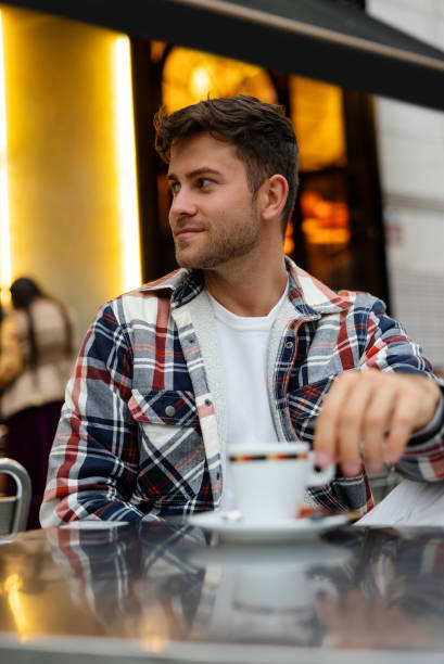 istock Man drinking coffee in street cafe 1351302340