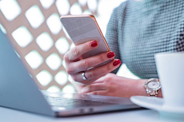 istock Close up of woman using smart phone in her office 1351302573