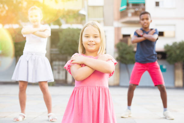 istock Smiling tween girl street dancer posing during performance with group 1351305306