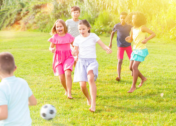 istock Active tweenagers playing football on green grass in summertime 1351305399