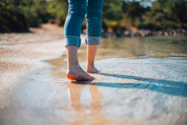 istock Close-Up Woman Walking on the Beach 1351306909
