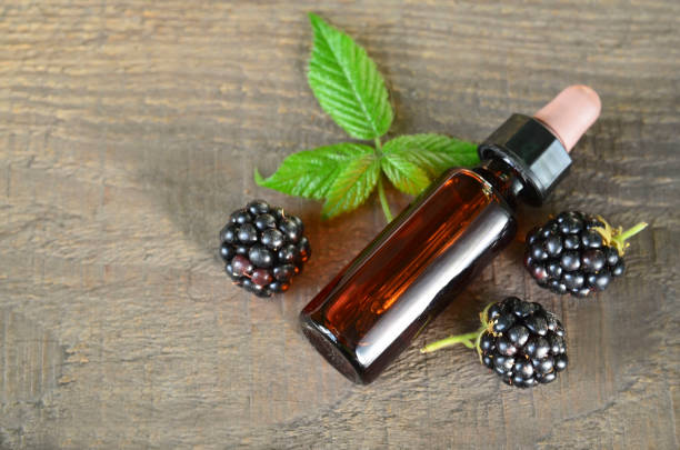 Blackberry seed essential oil in a glass bottle for skin care, naturopathy and wellness.Rubus villosus extract. stock photo