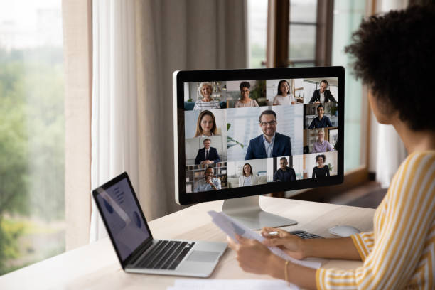 concentrated young african american woman holding videocall with diverse colleagues. - indian ethnicity audio imagens e fotografias de stock