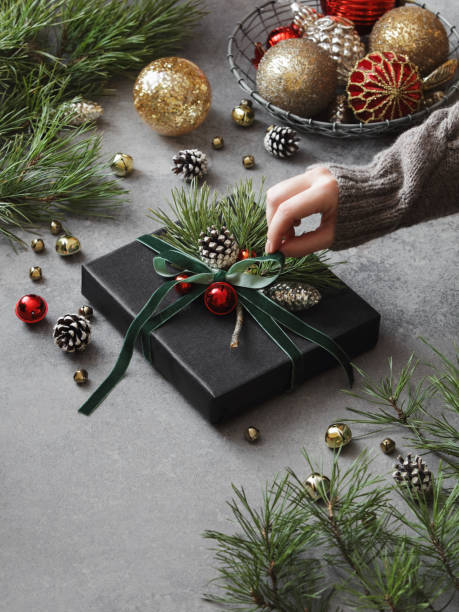 istock Woman decorating Christmas present 1351308932