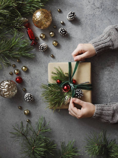 istock Woman decorating Christmas present 1351309073