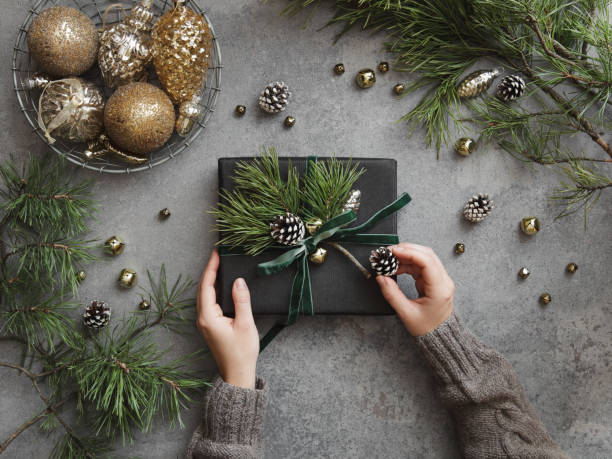 istock Woman decorating Christmas present 1351309151