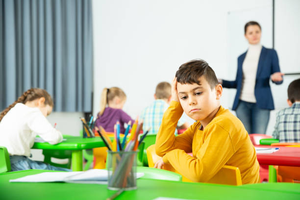 istock Upset boy in schoolroom 1351309291