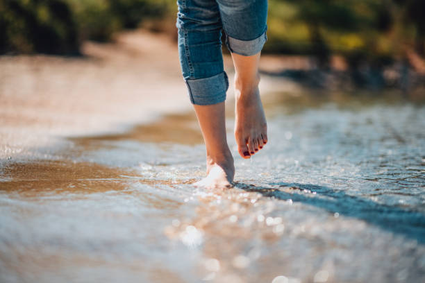 istock Close-Up Woman Walking on the Beach 1351309694