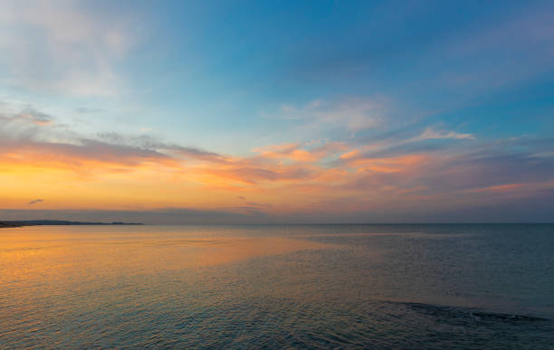 istock Colored clouds over the sea at sunset 1351311873