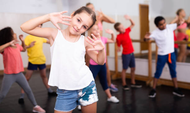 istock Girl exercising in group during dance class 1351312344