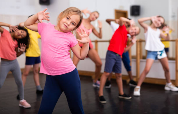 istock Girl exercising in group during dance class 1351312351