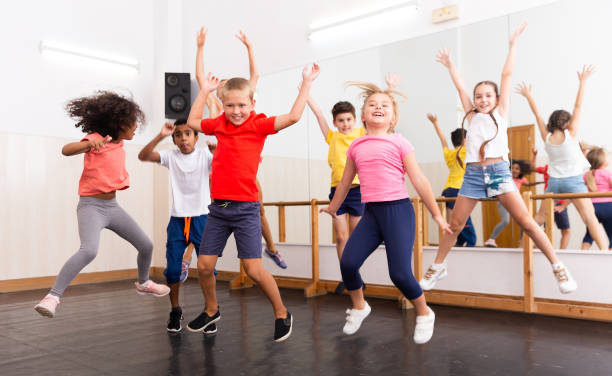 istock Boys and girls jumping in dance studio 1351312365