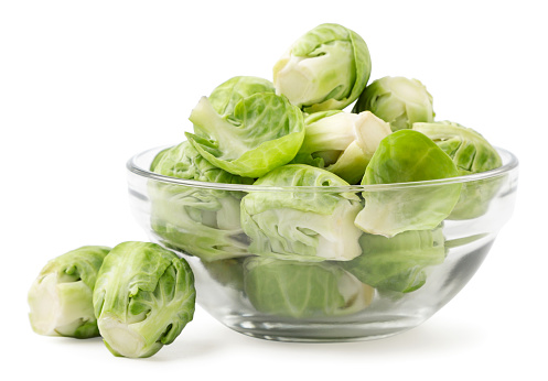 Brussels sprouts in a plate close-up on a white background. Isolated