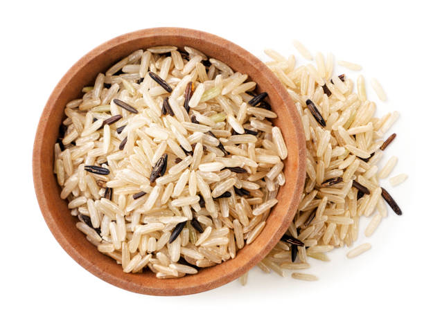 istock Wild unpolished rice in a plate on a white background, isolated. Top view 1351313914