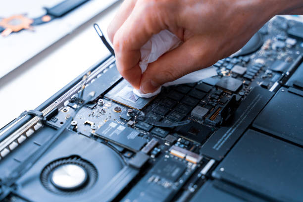 istock Computer repair man. Pc technician service with laptop on hardware background. Maintenance engineer support. Electronic technology development concept. 1351315202