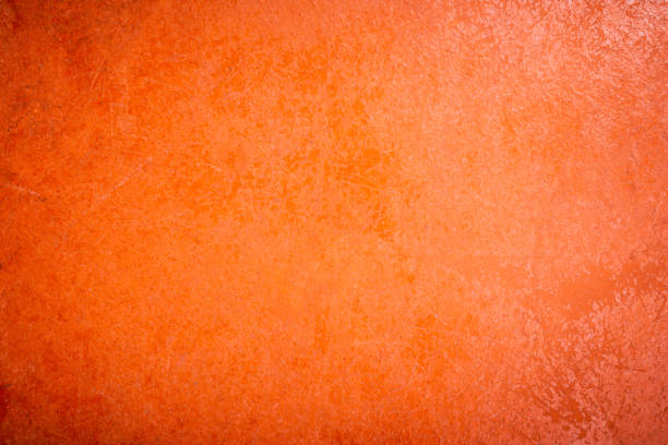 istock Yellow skin with cracks and scratches, old rough orange plaster wall surface Artistic. 1351317854