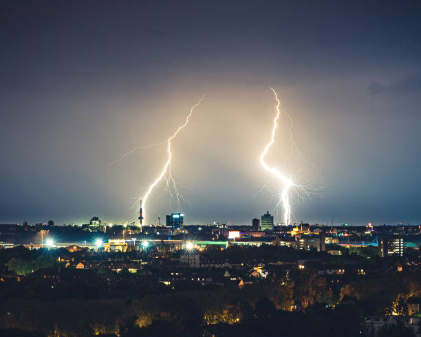 Lightning strike in a city Lightning strike in a city. Thunderstorm and rain in night. air attack stock pictures, royalty-free photos & images