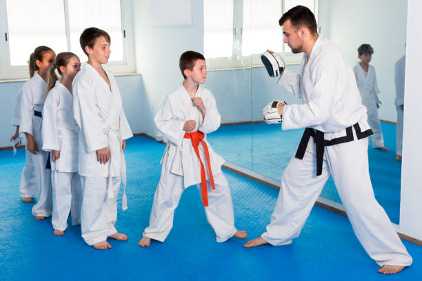 istock Teenagers are practicing on boxing paws with coach 1351318371