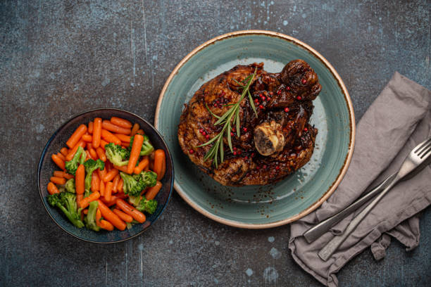 istock Roasted pork knuckle and salad top view 1351319410
