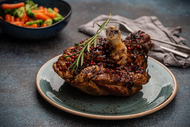 istock Roasted pork knuckle and salad angle view 1351319422