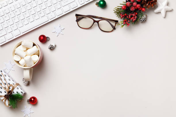 istock Winter desktop. New Year Christmas composition. Keyboard glasses gift marshmallow on gray table. Flat lay top view 1351320370