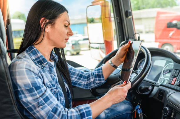 istock Female truck driver using a mobile app 1351320756