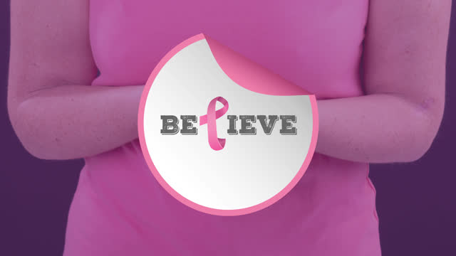 Video of breast cancer awareness text over caucasian woman holding pink cancer awareness ribbon