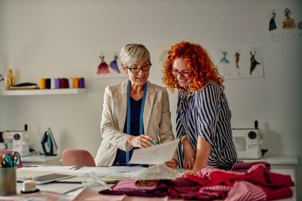 istock Fashion designers with sketches 1351323388