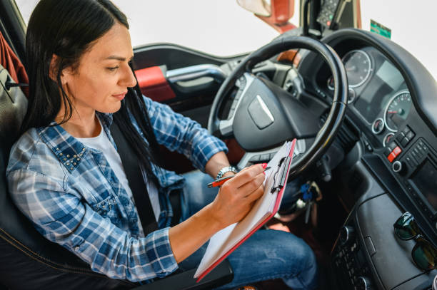 istock Female truck driver writing on a clipboard 1351323585
