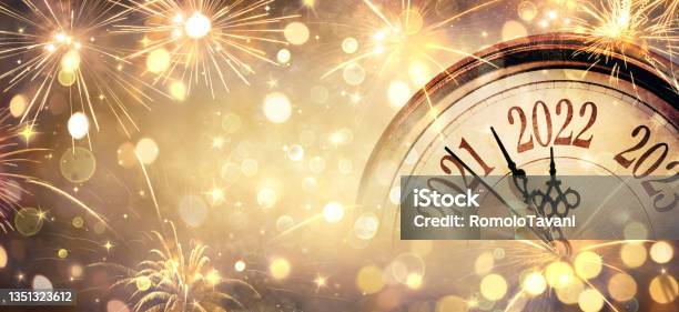 2022 New Year Clock And Fireworks Countdown To Midnight Abstract Defocused Background Stock Photo - Download Image Now