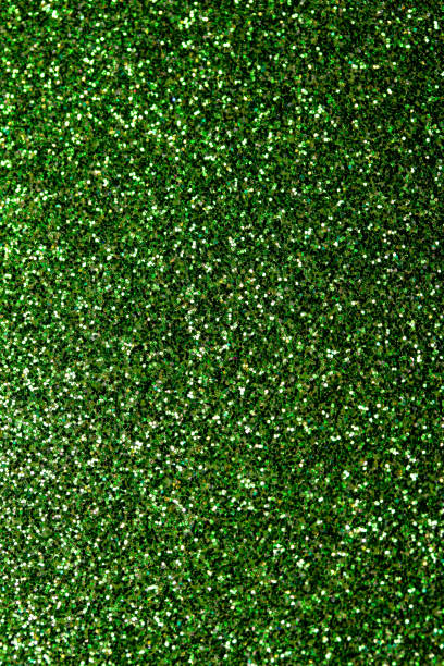 istock Shimmering green glitter macro abstract texture background with bokeh 1351324426