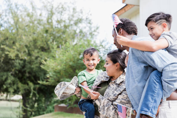 istock Boy looks at camera as family waves flags 1351328669