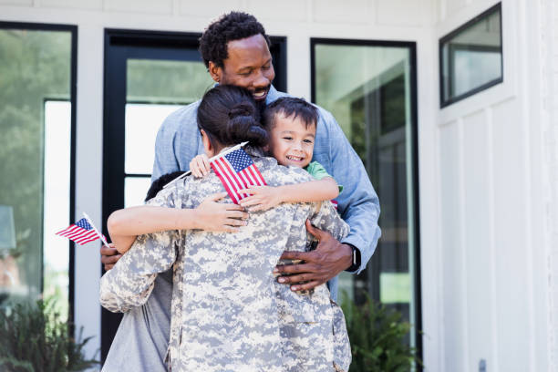 istock Holding flags, husband and children hug unrecognizable soldier mother 1351328677