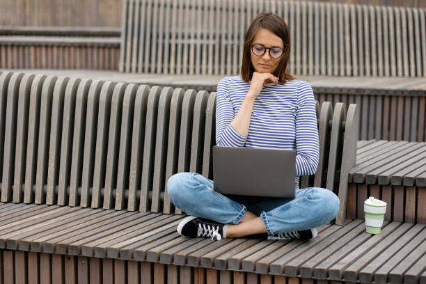 istock young and confident woman blogger or marketer drinking coffee and working on her laptop. work in a park or public place. social media or work as a top manager 1351330498