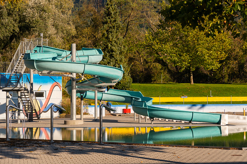 Vaduz, Liechtenstein, October 14, 2021 Funny water slide in a public swimming pool after the seasons end with no more guests there