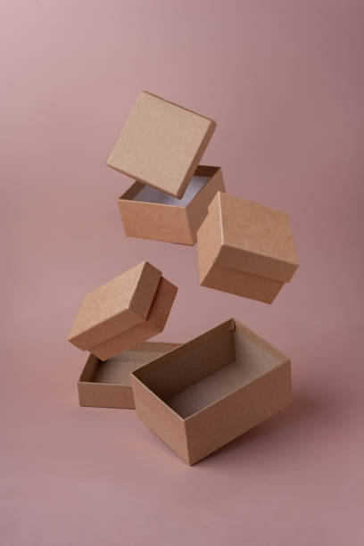 istock eco friendly craft boxes fly in the air on pink background selective focus Boxing day 1351331893