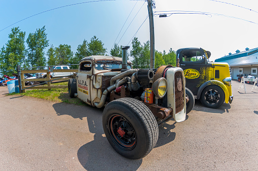 Moncton, New Brunswick, Canada - July 11, 2015 :  Diesel powered 1940 Ford rat rod pickup & customized 1938 Mack truck on display in Centennial Park during 2015 Atlantic Nationals, Moncton, NB Canada.