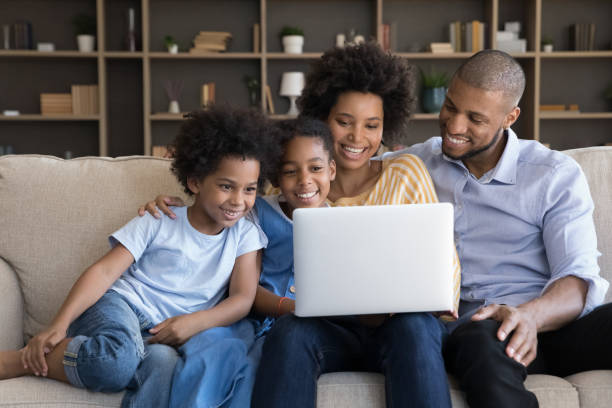 istock Happy loving african american family using computer at home. 1351333912