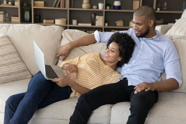 istock Happy relaxed young african american family couple using computer. 1351333938