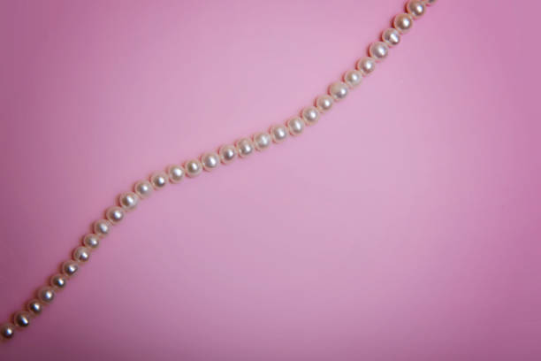 istock Pearl beads on a pale pink background. 1351336693