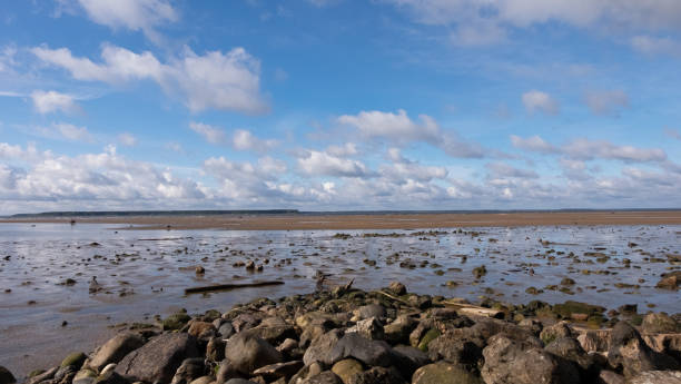 istock cloud on a sunny day with stone on the coast 1351337742