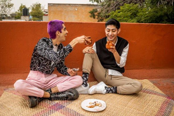istock Young men sitting and drinking coffee at rooftop 1351338213