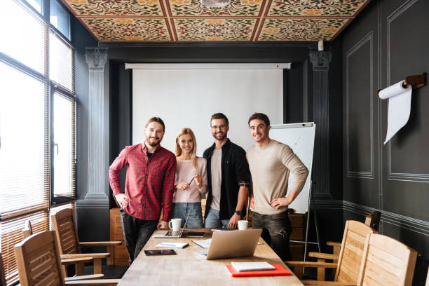 istock Young attractive colleagues standing and coworking 1351338754