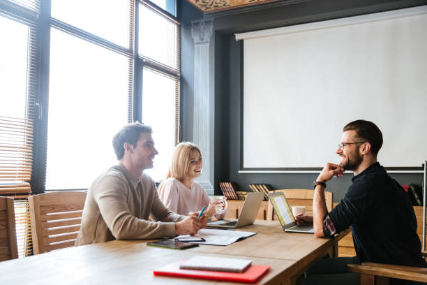 istock Three young happy colleagues coworking. 1351338842