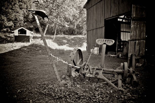 istock Old rusty hay sickle outside of barn. 1351339480