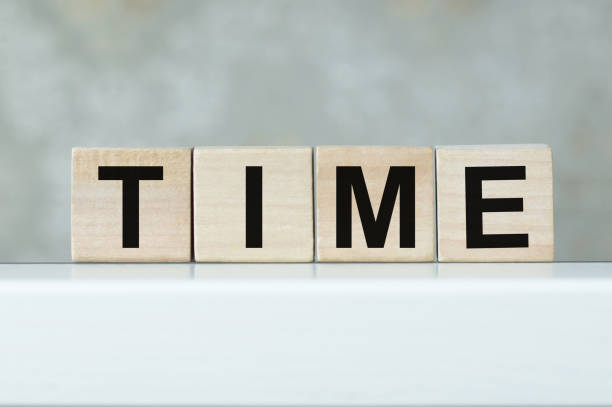 istock Text Time on wood cube block, stock investment concept. 1351341464