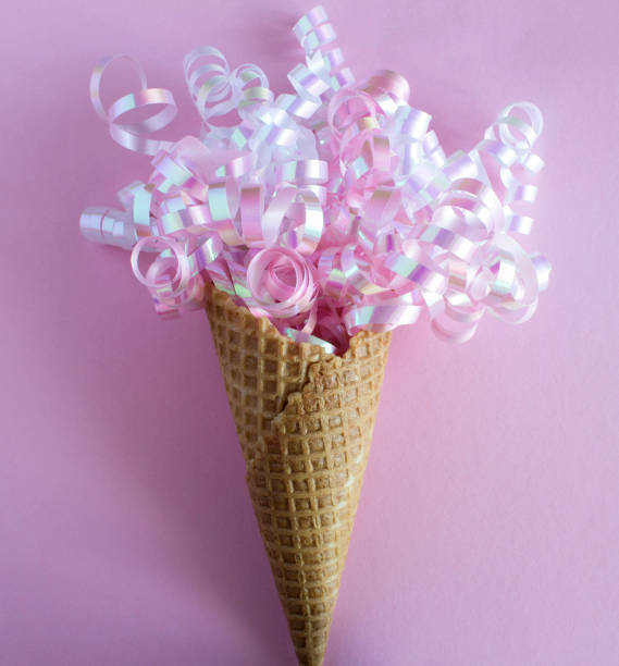 istock Close-up on ice cream cone with conffetti on the pink background 1351342304