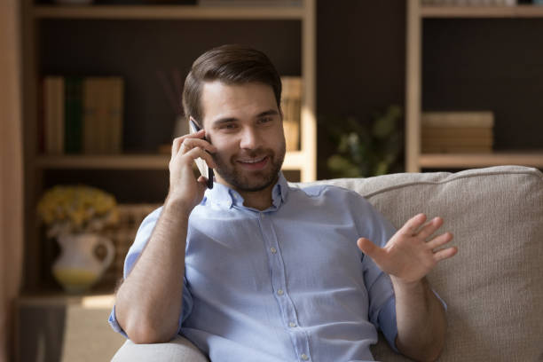 istock Happy Caucasian millennial man holding phone call conversation. 1351342426