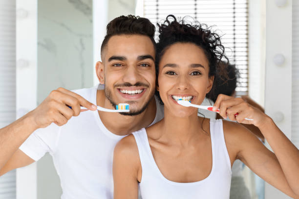 istock Cheerful Young Middle Eastern Couple Brushing Teeth Together And Smiling At Camera 1351342472